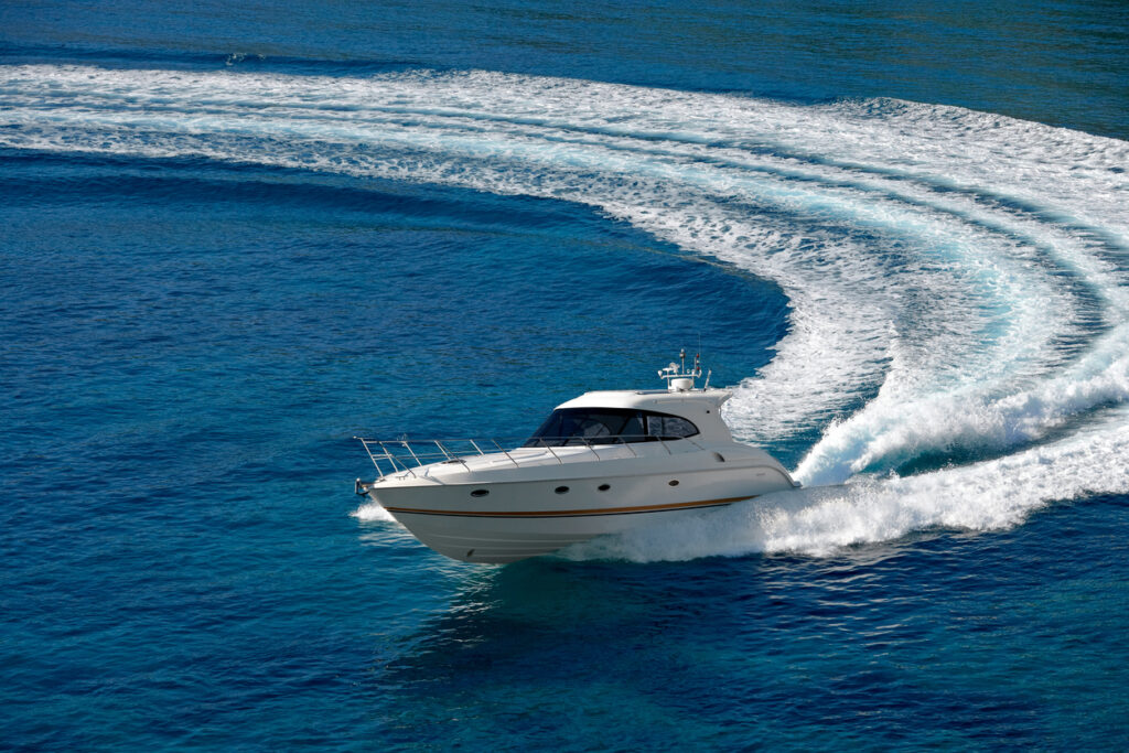 White speedboat on blue ocean representing Brunswick Corporation marine manufacturing and API integration success