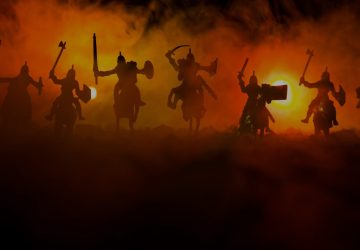 Silhouetted medieval warriors in battle formation against fiery sunset representing resistance to change and conflict