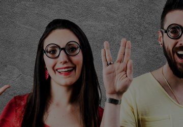 Two people making Vulcan salute hand gesture with glasses representing Star Trek live long and prosper theme