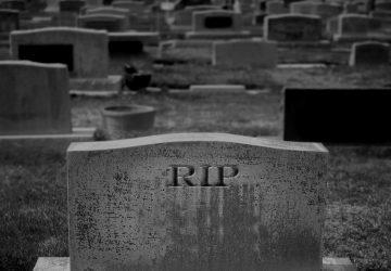 Cemetery gravestone with RIP text representing death of rip-and-replace IBM i modernization strategies